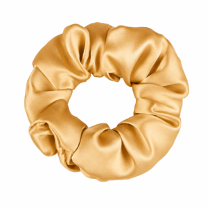 Gold satin scrunchie looped into a circular hair accessory on a white background