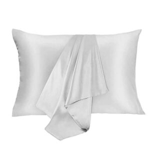 White pillow with a folded white throw blanket draped across the center.